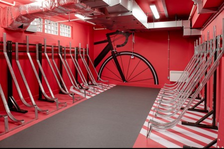 Prudential Buildings, Bristol - bicycle storage on both sides with red walls and black graphic depicting a bike on the wall