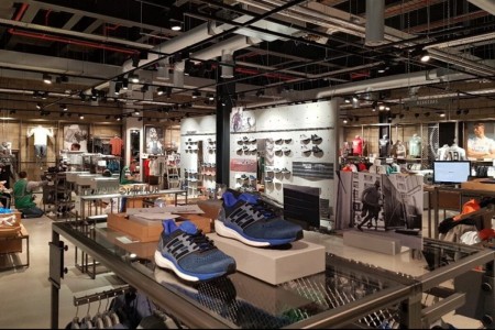 Adidas trainers and interior of shop with bespoke fittings