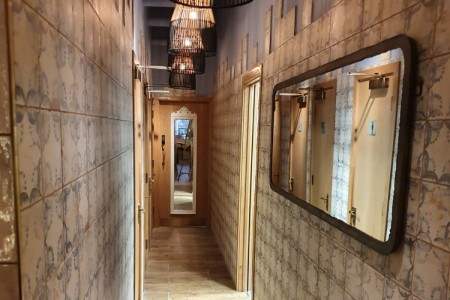 Megan's, Islington - hallway with toilet doors, tiles, mirrors and wooden lampshades