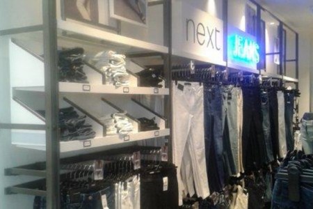 Next, Havant - clothing displays with neon JEANS sign