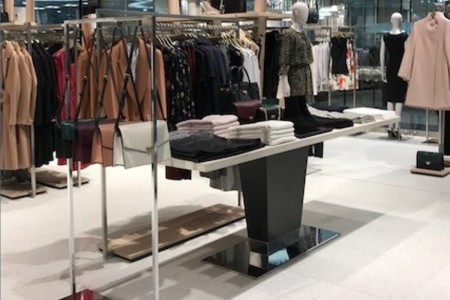 Reiss, Canary Wharf - bespoke shopfittings including white tiled floor, display tables and racking