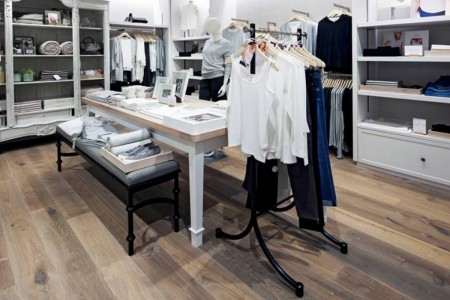 The White Company, Norwich - hardwood floor, white and wooden table with products on, clothes rail with hanging clothes
