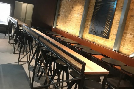Starbucks, London Bridge - wooden tables, stools and chairs, exposed brickwork