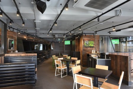 Shake Shack, Leicester Square - seating area with benches, tables and chairs, wooden clad walls