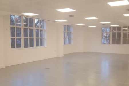 Meyer Bergman, Mayfair - large office space with grey floor and white walls, fluorescent lighting