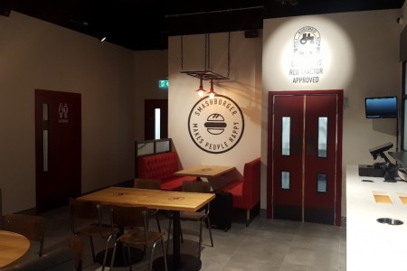 Smashburger, Dunfermline - white walls, red leather booth seating, red doors to toilets, wooden tables and chairs