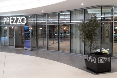 Prezzo, Bournemouth - shopfront with glass exterior and lit up branding