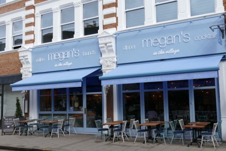 Megan's, Wimbledon - exterior of shopfront, with blue and white branding and tables and chairs outside