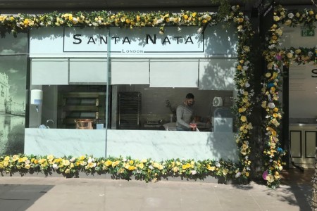 Santa Nata, London - exterior, glass shopfront surrounded by yellow flowers