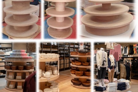 Muji, Lyon, France - round display units shown empty and filled with products like clothing and kitchenware 