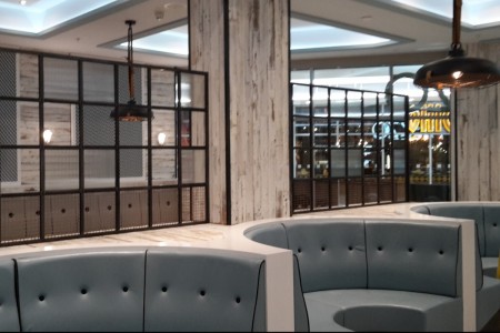 Prezzo, Bournemouth - circular blue booth seating, distressed white wooden paneling on walls